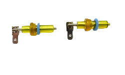 Two small metal components with yellow and blue accents on a ruler for scale.